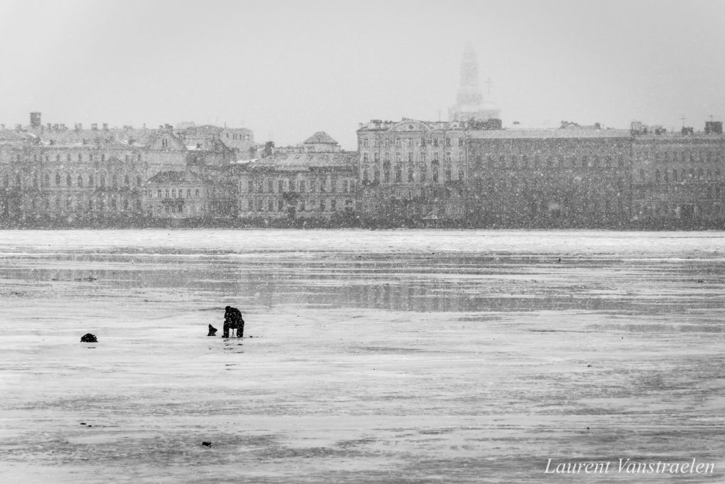 Russian fisher on a frozen canal in Saint Petersburg