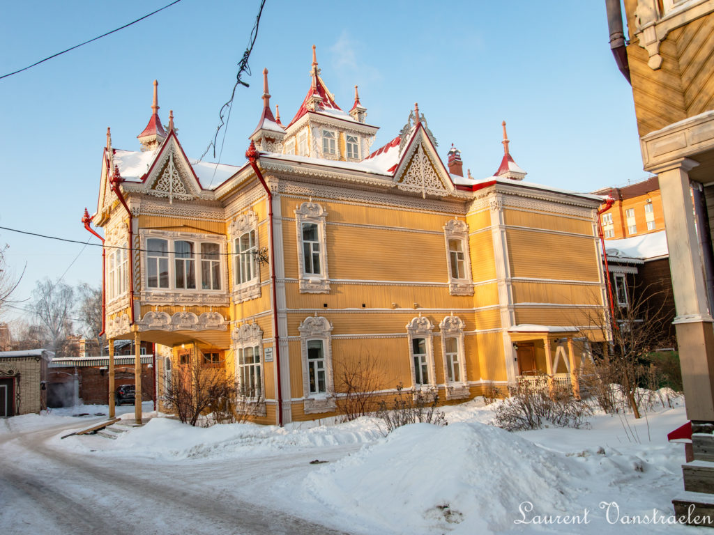 Orange wooden house. The house with firebirds in winter